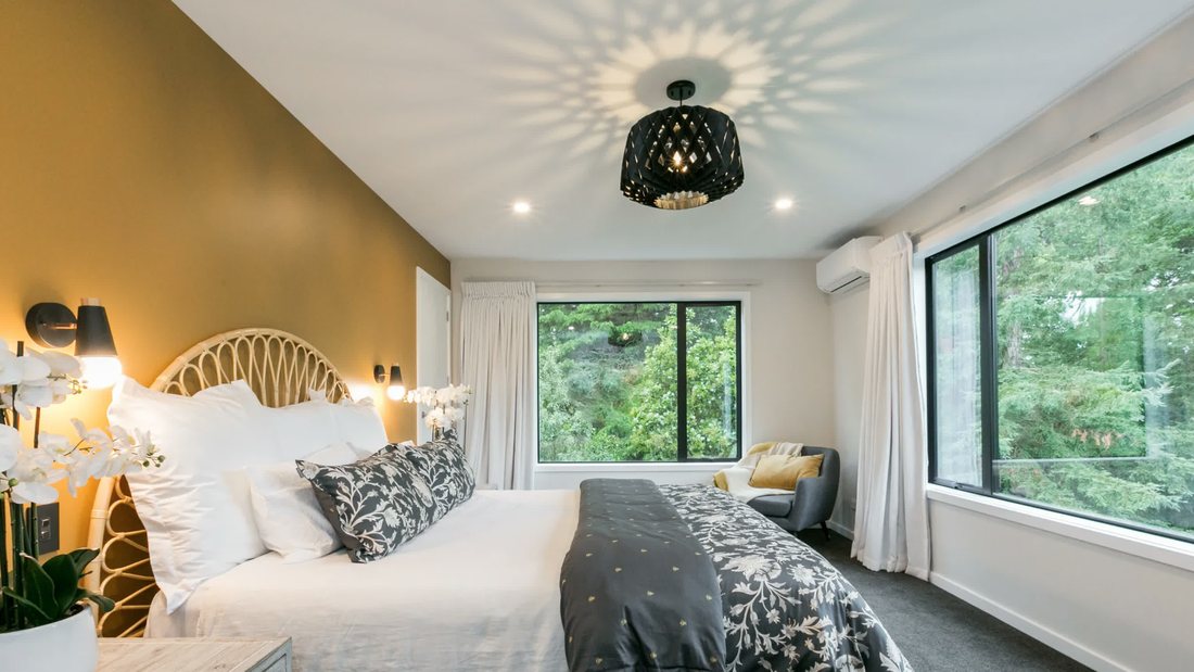 Bedroom with a feature wall and skylight